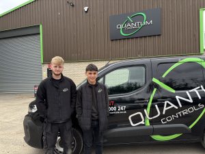Robbie and Ryle pictured next to a Quantum Controls Van